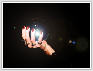 woman's hand holding a crystal ball