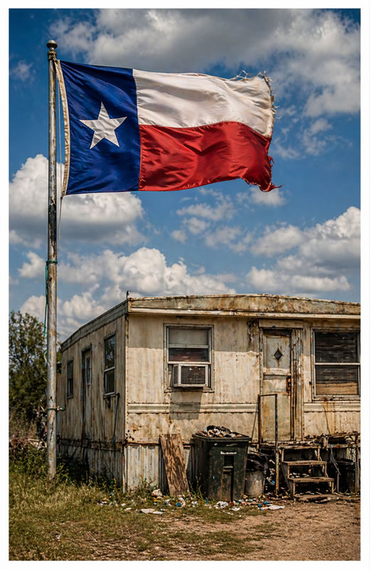 Texas flag flying over a trashy trailer